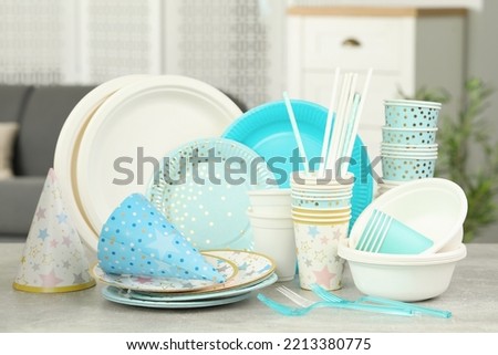 Disposable tableware on light grey table indoors Royalty-Free Stock Photo #2213380775