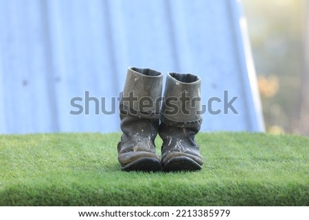 old dirty boots on the grass