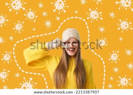 Happy young woman and drawn virus on orange background. Concept of strong immunity Royalty-Free Stock Photo #2213387907