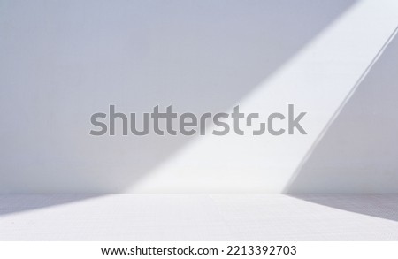 Original widescreen background image in minimalistic design with geometric shapes of light and shadow for presentation of various products in grey-blue tones. Royalty-Free Stock Photo #2213392703