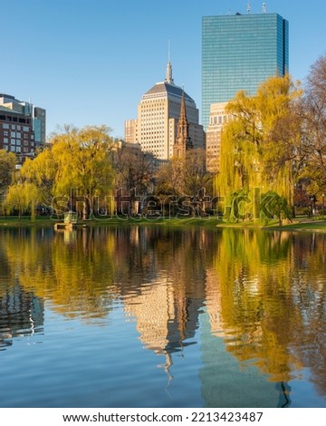 View of the Boston Public Garden with reflection in the duck pond of the city.   