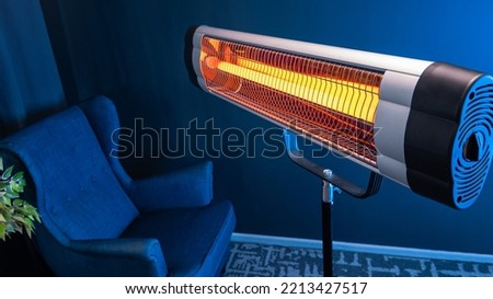 Modern electric infrared heater in living room Royalty-Free Stock Photo #2213427517