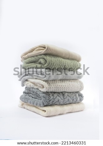 Autumn winter season
 ,Stack of cozy knitted warm sweater., 
 Royalty-Free Stock Photo #2213460331