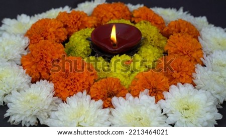 Happy Diwali - Lit diya lamp on street at night. Happy Diwali. Diya oil lamp and flowers. Traditional Hindu celebration. Religious holiday of light. Copy space, banner format.