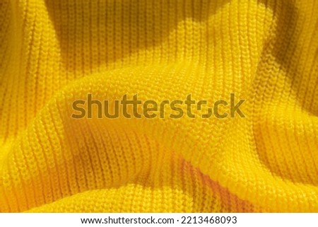 Yellow textile background. Wallpaper. Knitted background.