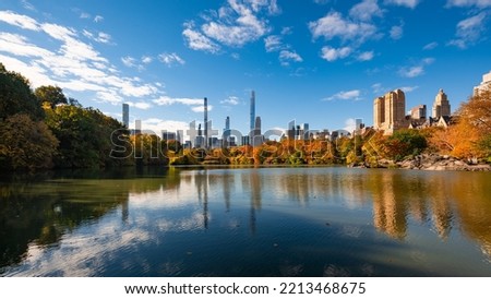 Central Park in Autumn with Billionaires Row skyscrapers from the Lake. Upper West Side, Manhattan, New York City Royalty-Free Stock Photo #2213468675