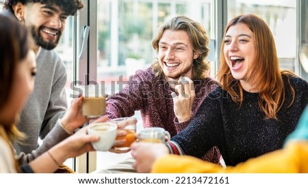 Friends group toasting latte at coffee bar patio - People talking and having fun together at cappuccino restaurant - Life style concept with happy guys and girls at cafe terrace - Bright warm filter Royalty-Free Stock Photo #2213472161