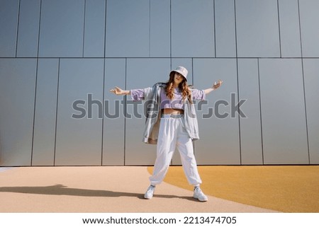 Woman dancerfront of wall. Breakdancing, street dancing, hiphop, freestyle dance.