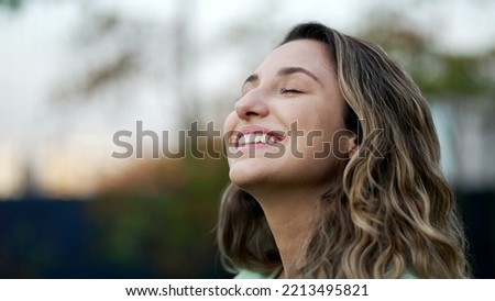 Portrait of a grateful contemplative young woman closeup face. Meditative 20s girl opening eyes to sky with gratitude Royalty-Free Stock Photo #2213495821