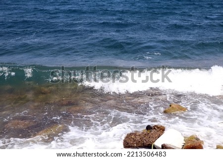 Photo of waves hitting rocks