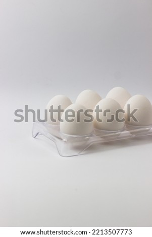 Chicken eggs in a tray on a white background. Ingredients for cooking