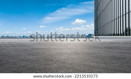 Asphalt road ground and city skyline with modern commercial building in Suzhou, China.  Royalty-Free Stock Photo #2213510173