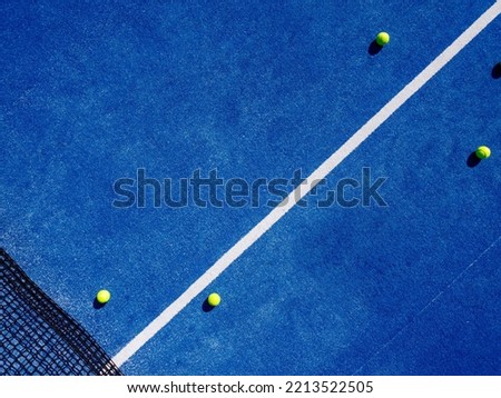zenithal aerial view of two balls in a blue paddle tennis court Royalty-Free Stock Photo #2213522505