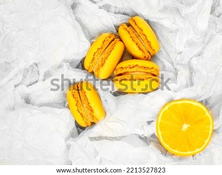 Yellow citrus macaroons and a slice of a fresh cut lemon