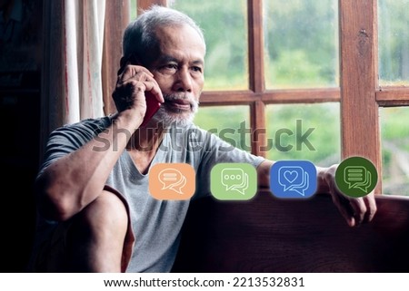 bearded senior man talking by phone