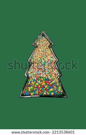 Christmas tree shaped frame filled with many colourful candy sprinkles on green background with copy space. Creative New Year wallpaper idea. Flat lay lay out party theme. 