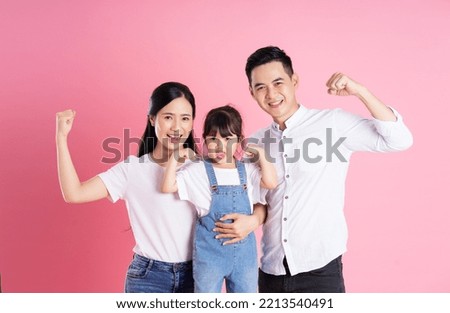 happy young asian family image, isolated on pink background