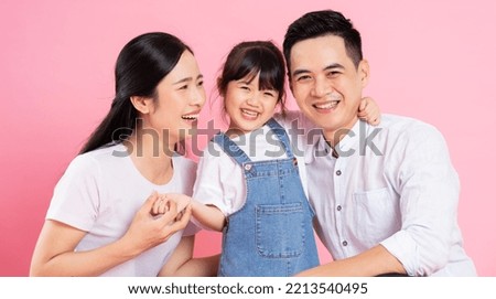 happy young asian family image, isolated on pink background