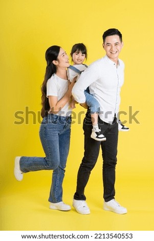 happy asian family image, isolated on yellow background Royalty-Free Stock Photo #2213540553