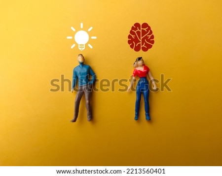 Miniatures of a man and a woman with the idea and brain icons over their head on a yellow background