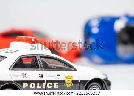 A toy police car arriving at the scene of a traffic accident.