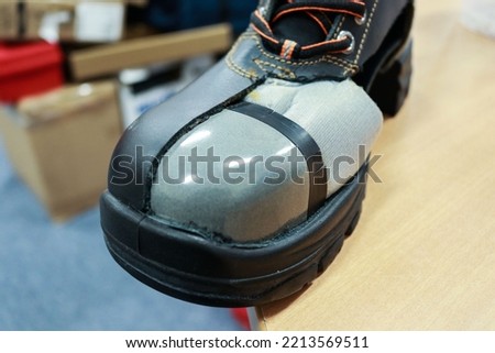 Steel toe cap is a steel plate on the toe of safety shoes to protect the feet from the impact of hard objects Royalty-Free Stock Photo #2213569511