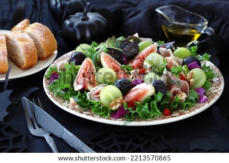 Autumn salad with  fig and grape on plate
