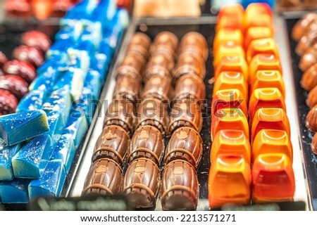 Colorful small chocolate cakes in a row.