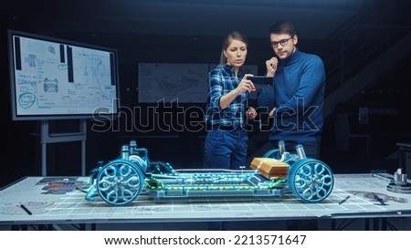 Automotive Engineers Working on 3D Electric Car Design Through Smartphone AR Software. Using Gestures in Augmented Reality. Designing Graphical Parts, Picks Body and Color for the Chassis, Engine