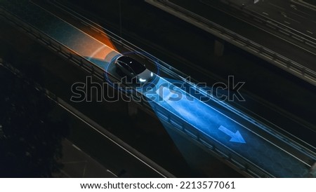 Following Aerial Top Down Drone View: Autonomous Self Driving Car Moving Through City Highway. AI Visualization Concept: High Tech Sensor Scanning Road Ahead for Vehicles and Speed Limits.