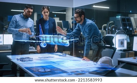 Aeronautics Factory Office Meeting Room: Team of Diverse Engineers and Managers Work on an Augmented Reality Airplane Jet Engine Simulation. Advanced Industry 4.0 Research and Development. Royalty-Free Stock Photo #2213583993