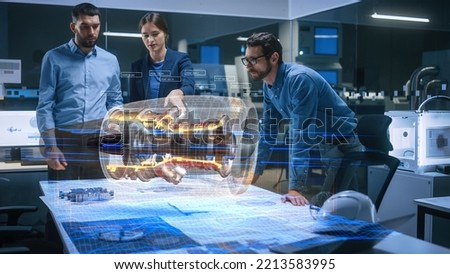 Aeronautics Factory Meeting Room: Team of Diverse Engineers and Managers Work on an Augmented Reality Airplane Jet Engine Simulation. Advanced Industry 4.0 Research and Development. Royalty-Free Stock Photo #2213583995