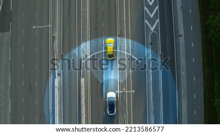 Aerial Top Down View: Autonomous Self Driving Car Moving Through City, Overtaking Other Vehicles. Scanning Visualization Concept: Artificial Intelligence Digitalizes and Analyzes Road Ahead. Royalty-Free Stock Photo #2213586577