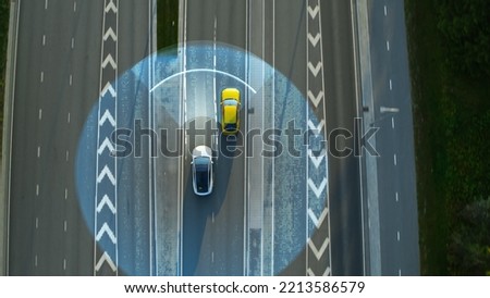 Aerial Top Down View: Autonomous Self Driving Car Moving Through City, Passing Other Vehicles. Scanning Visualization Futuristic Concept: Artificial Intelligence Digitalizes and Analyzes Road Ahead.