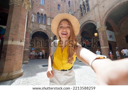 Tourism in Italy. Selfie picture of traveler girl visiting Siena historic town of Tuscany, Italy.