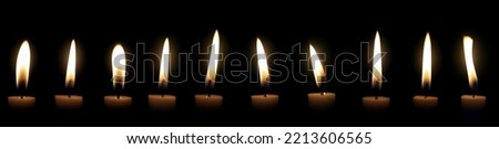The candle flame glows in the dark dark night as a background decoration in religious ceremonies and birthday celebrations. Many people have a happybrightromantic holiday.