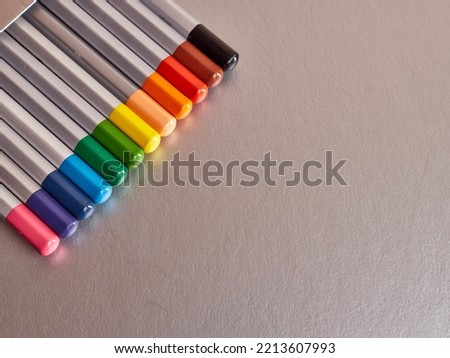 A set of colored pencils on a gray background. Stationery for creativity and learning.