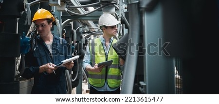 Engineer and team examining the air conditioning cooling system of a huge building or industrial site. Royalty-Free Stock Photo #2213615477
