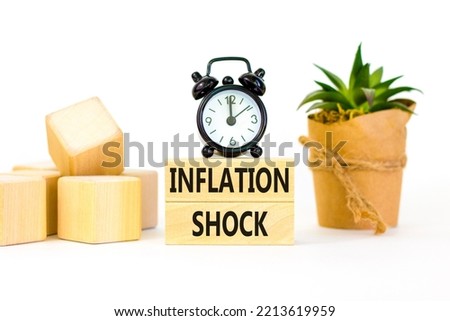 Inflation shock symbol. Concept words Inflation shock on wooden blocks. Beautiful white table white background. Black alarm clock. House plant. Business inflation shock concept. Copy space.