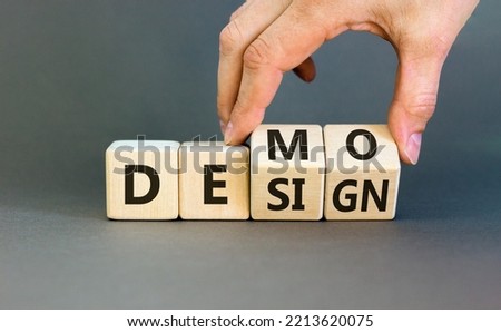 Demo and design symbol. Businessman hand turns cubes and changes the word 'design' to 'demo'. Beautiful grey background. Business demo and design concept. Copy space.