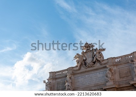 CParticular of the Decoration on the Top of the Trevi's Funtain in the Centre of Rome on Partially Cloudy Sky Background