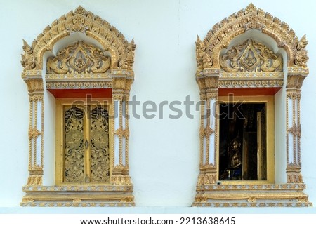Thai pattern picture with gold gilding on black background on the window of the church in the monastery