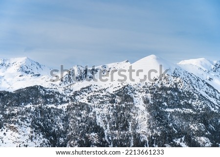 Snow capped mountain peaks of mountain range in Pyrenees Mountains. Winter ski holidays in El Tarter, Grandvalira, Andorra