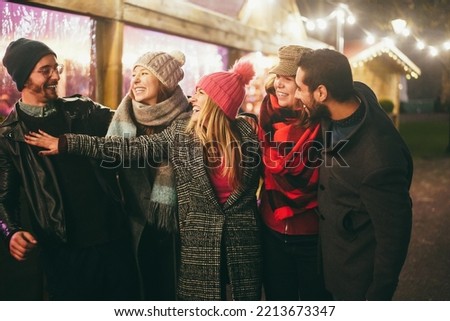 Young friends having fun outdoor during winter time - Soft focus on right girl face Royalty-Free Stock Photo #2213673347