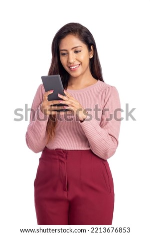 Cheerful Indian young woman using smart phone. Royalty-Free Stock Photo #2213676853