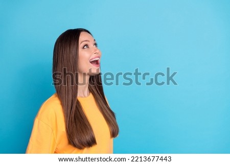 Profile side photo of pretty astonished lady look huge black friday promo ad empty space wait big sales isolated on blue color background