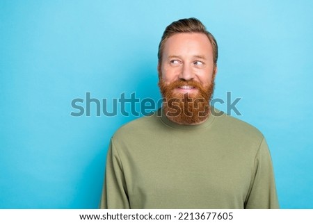 Portrait of funny optimistic cheerful guy with red hairdo dressed khaki pullover look empty space isolated on turquoise color background