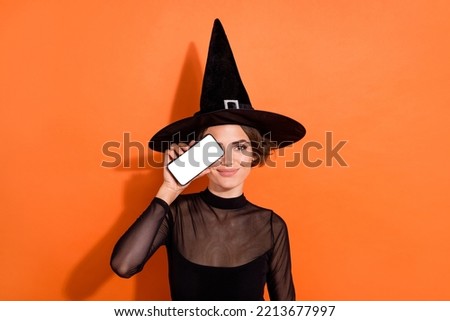Photo of attractive enchant lady hand hold show empty space telephone display cover eye isolated on orange color background