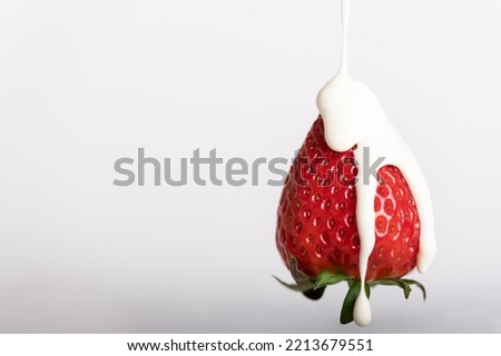 Strawberries with cream. Strawberries bowl with cream in a white backdrop. Strawberries on white wood. Strawberry milkshake with white background.