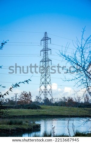 Power lines in a field of a french countryside